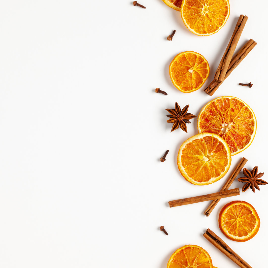 Christmas composition with dried oranges and spices on white background. Natural food ingredient for cooking or Christmas decor for home. Flat lay.